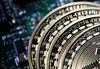 Three coins representing Bitcoin cryptocurrency sit on a computer circuit board in this arranged photograph in London, U.K.