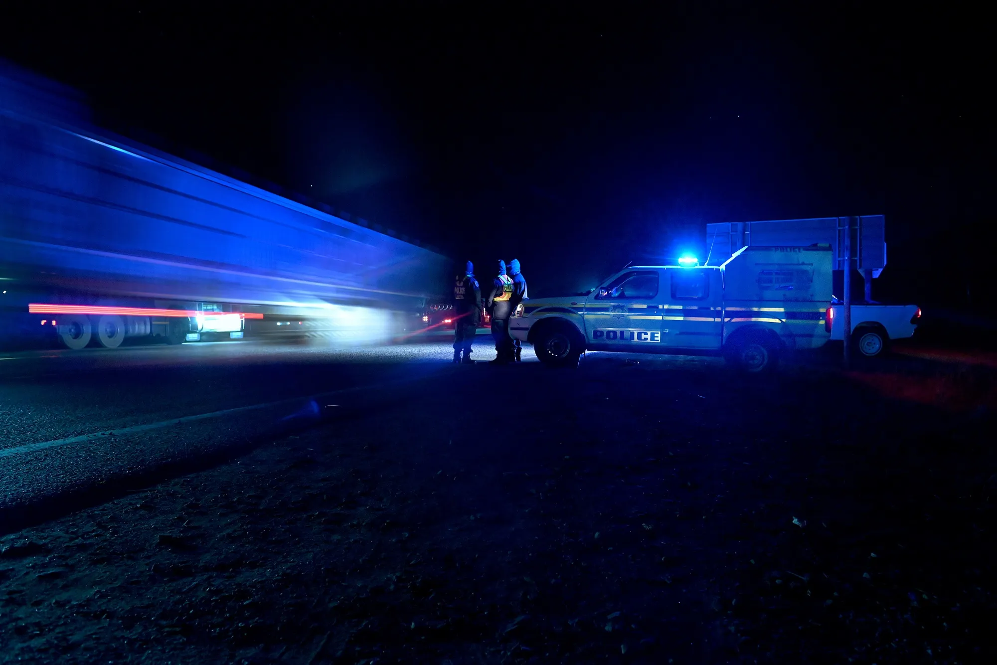 Trucks pass a police check point on the N4 national highway near Komatipoort, South Africa.