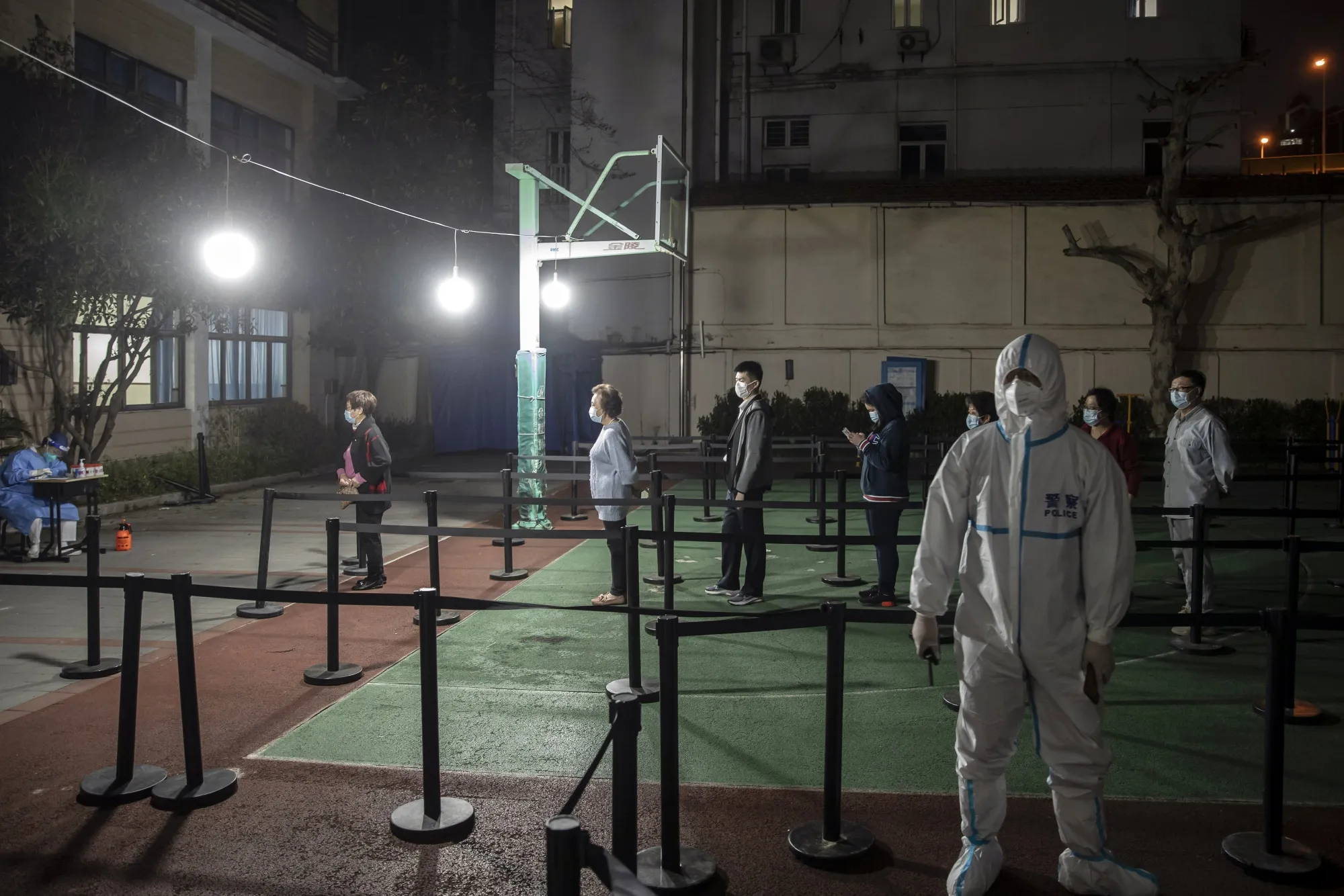 Residents line up to be tested at a Shanghai neighborhood placed under lockdown on March 16.