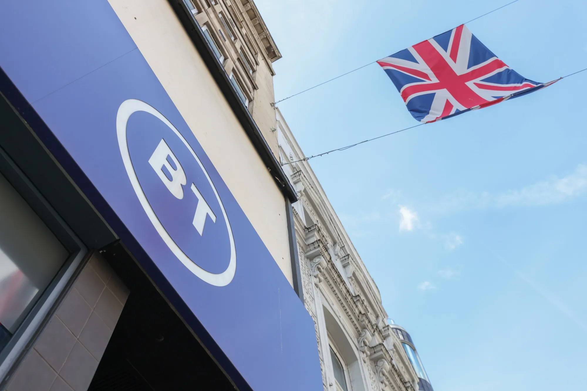 A BT Group Plc logo on a EE/BT Group Plc store in London, UK, on Wednesday, May 17, 2023. The fiber storm buffeting telecom carriers shouldn’t have prevented BT from meeting its earnings and free cash flow targets in results when it reports on Thursday.