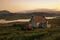 A view of a croft house and tractor at Balallan on the Isle of Lewis in Scotland.