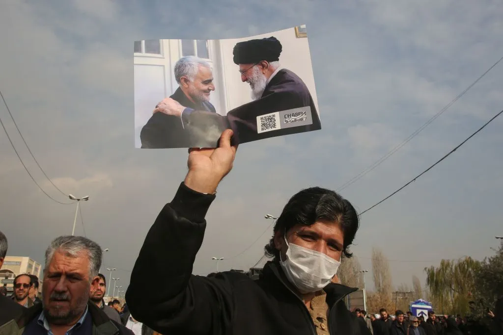 A man holds a picture of Iran's supreme leader Ayatollah Ali Khamenei with Iranian Revolutionary Guards Major General Qassem Soleimani (L) during a demonstration in Tehran&nbsp;against the killing of the top commander in a&nbsp;strike in Baghdad.