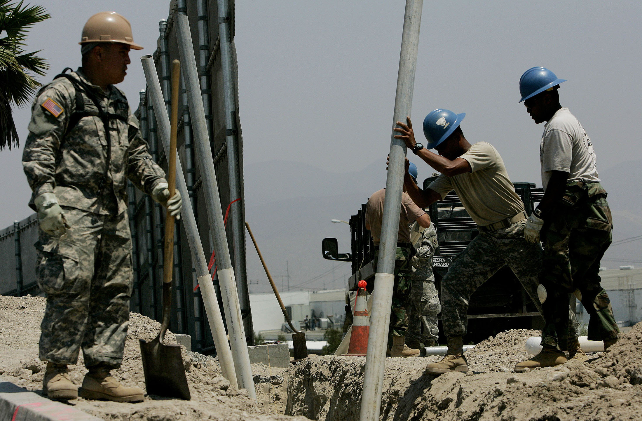 OTAY MESA, CA - JULY 25:  Members of the California National Guard prepare to bury plastic pipes for housing electrical wiring along the U.S.-Mexico Border July 25, 2006 in Otay Mesa, California. Approximately 1,000 volunteer Guardsmen are stationed along the California-Mexico border as part of Operation Jump Start, which is providing support for the border patrol agents by repairing fences, improving roads and manning surveillance cameras. The Guard are prohibited from engaging in overt law enforcement.  (Photo by Sandy Huffaker/Getty Images)