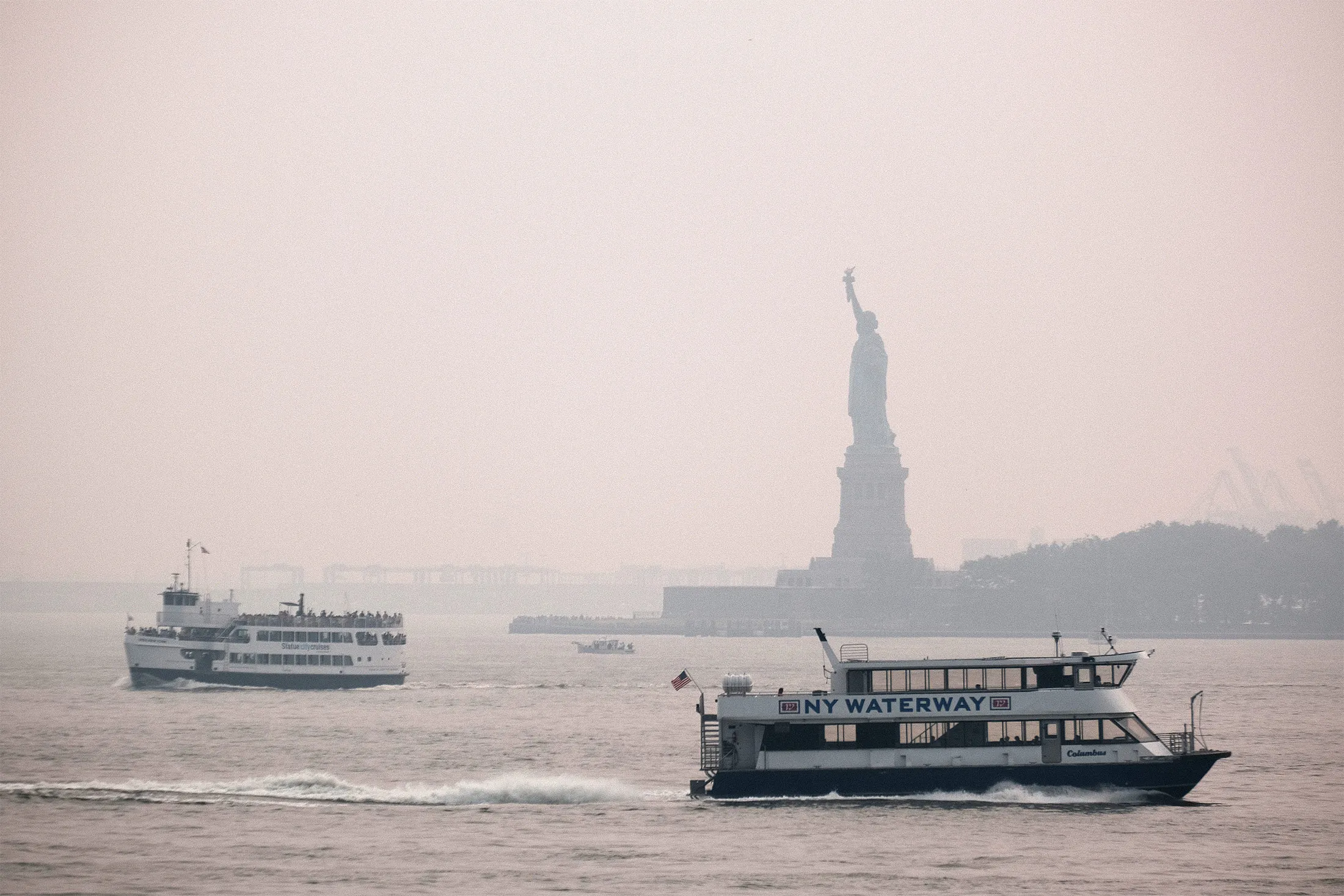 The Statue of Liberty sits behind a cloud of haze on July 20, as wildfire smoke from the West blanketed the largest U.S. city.