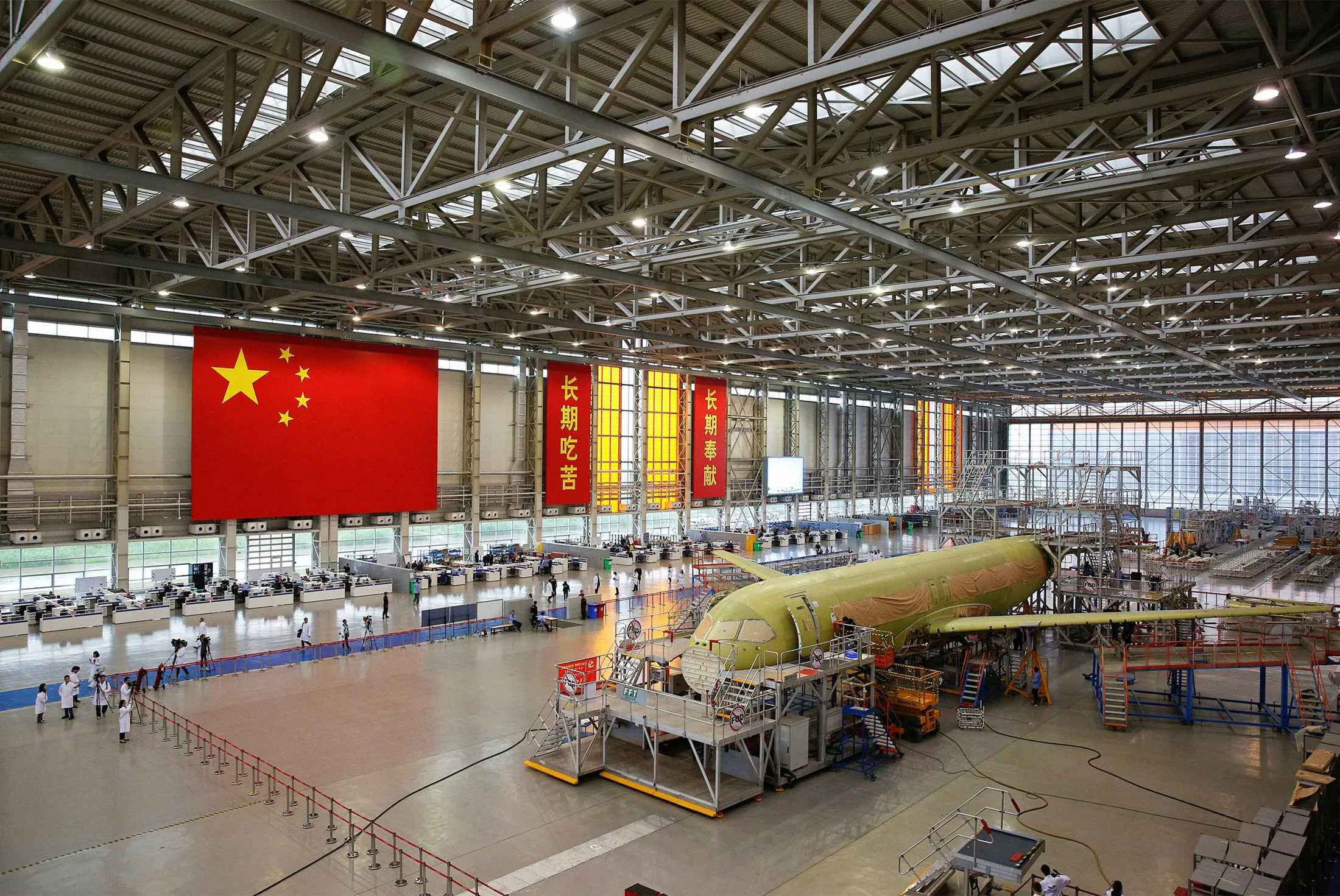 Employees work on China’s homegrown C919 passenger jet at the manufacturing and final assembly center of state-owned Commercial Aircraft Corp. of China in Shanghai on May 4, 2017.
