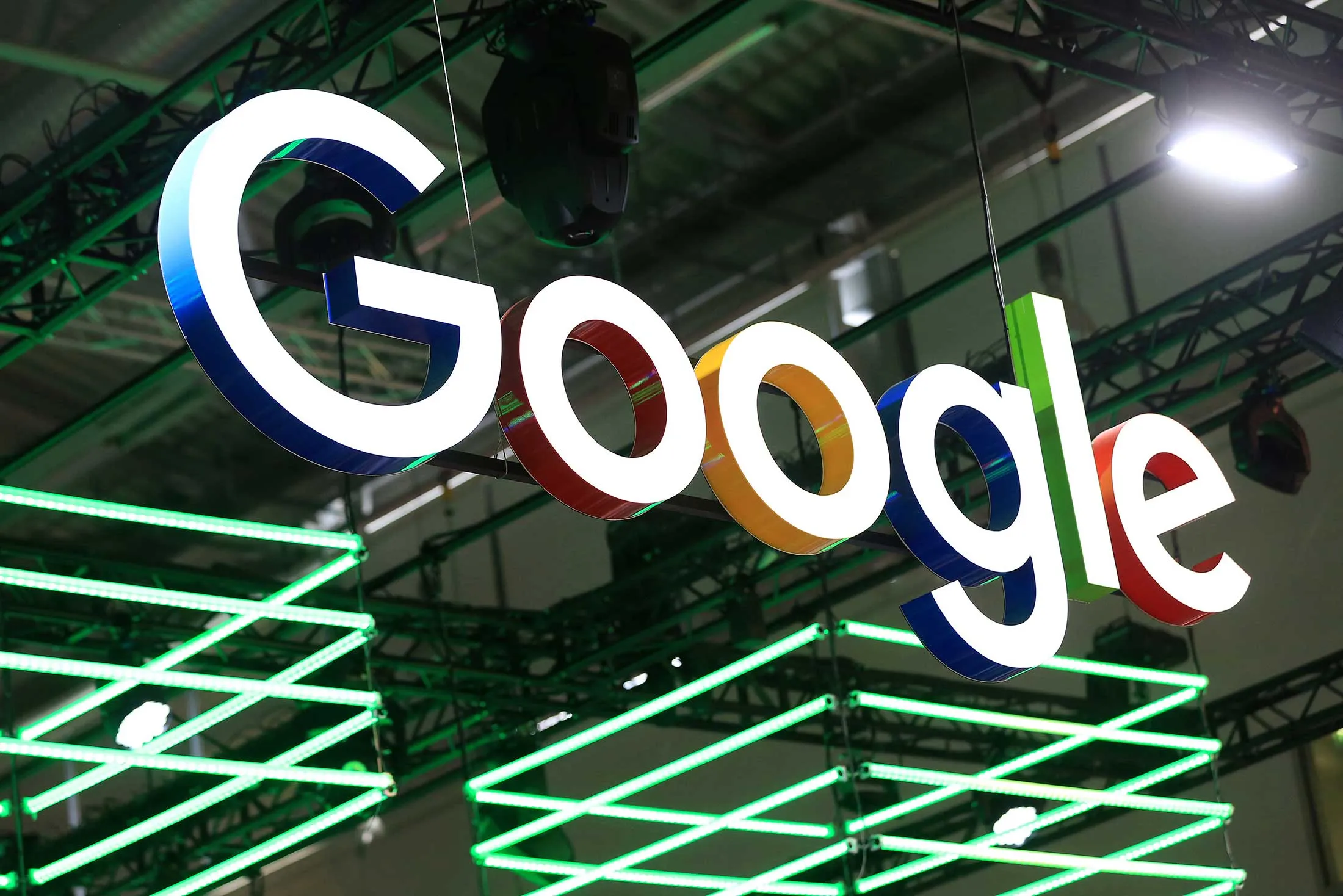 The Google Inc. logo hangs illuminated over the company's exhibition stand at the Dmexco digital marketing conference in Cologne, Germany, on Wednesday, Sept. 14, 2016. Dmexco is a two-day global business and digital economy innovation platform, attracting the industry's most important personalities and corporate decision-makers.
