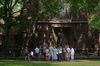 A tour group makes a stop at a statue of Theodore Woolsey on the Yale University campus.