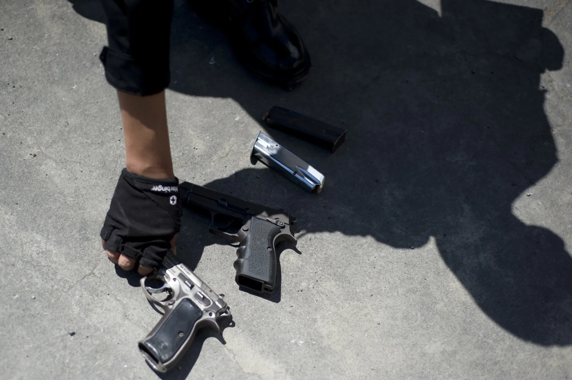 A police officer shows guns seized in the outskirts of Guatemala City.