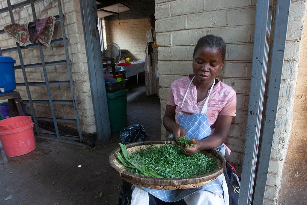 A restaurant worker slices vegetables in the&nbsp;Old town of&nbsp;Lilongwe,&nbsp;Malawi.