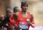 Britain's Mo Farah, right, runs as a pacemaker during the London Marathon in London, England, Oct. 4, 2020. Four-time Olympic champion Farah has disclosed he was brought into Britain illegally from Djibouti under the name of another child. “The truth is I’m not who you think I am,&quot; the 39-year-old Farah told the BBC in a documentary called “The Real Mo Farah.” (Adam Davy/Pool via AP, File)