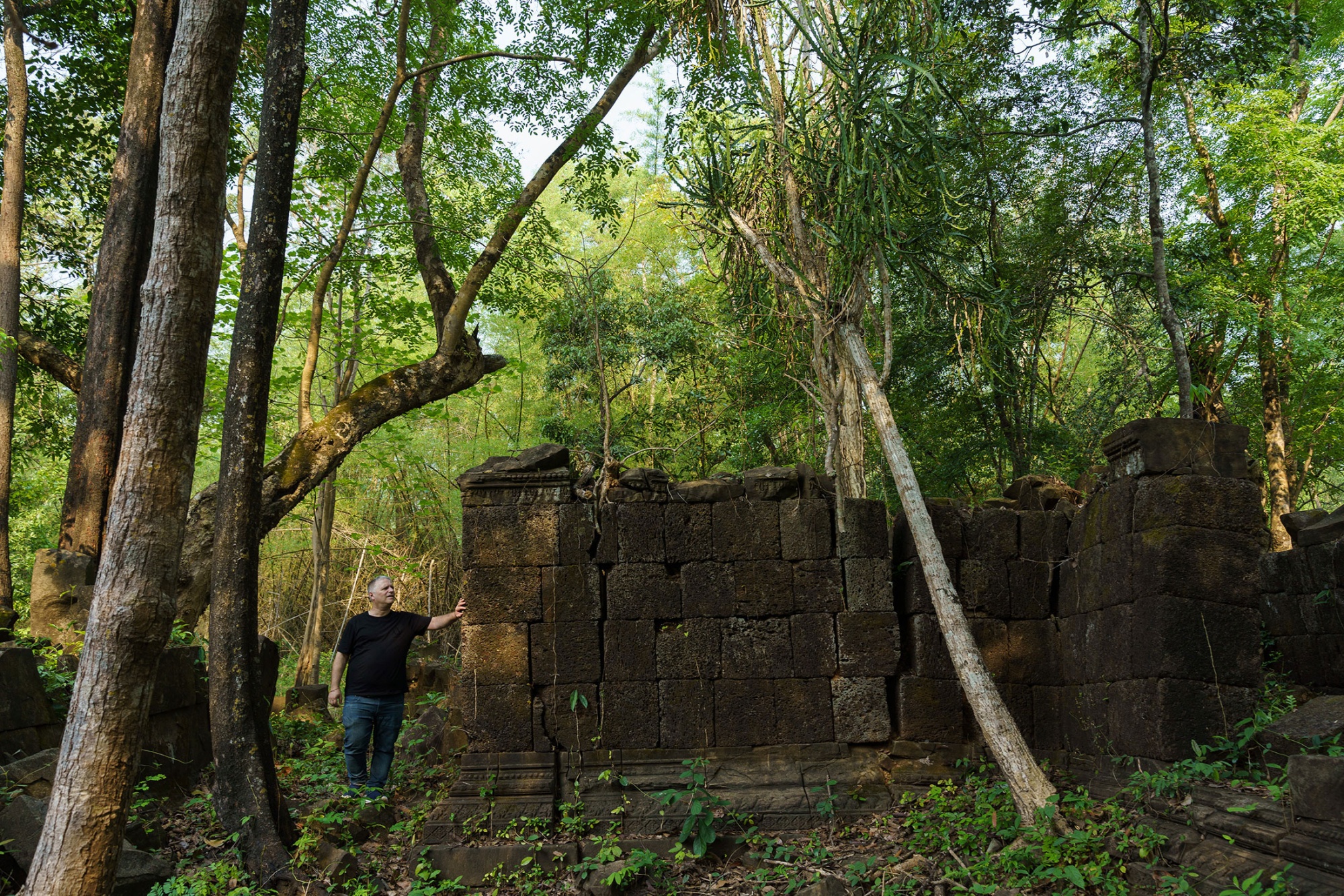 Bradley Gordon walks through ruins at Koh Ker, a heavily looted temple complex in Cambodia. Photographer: Thomas Cristofoletti/Edenbridge Asia