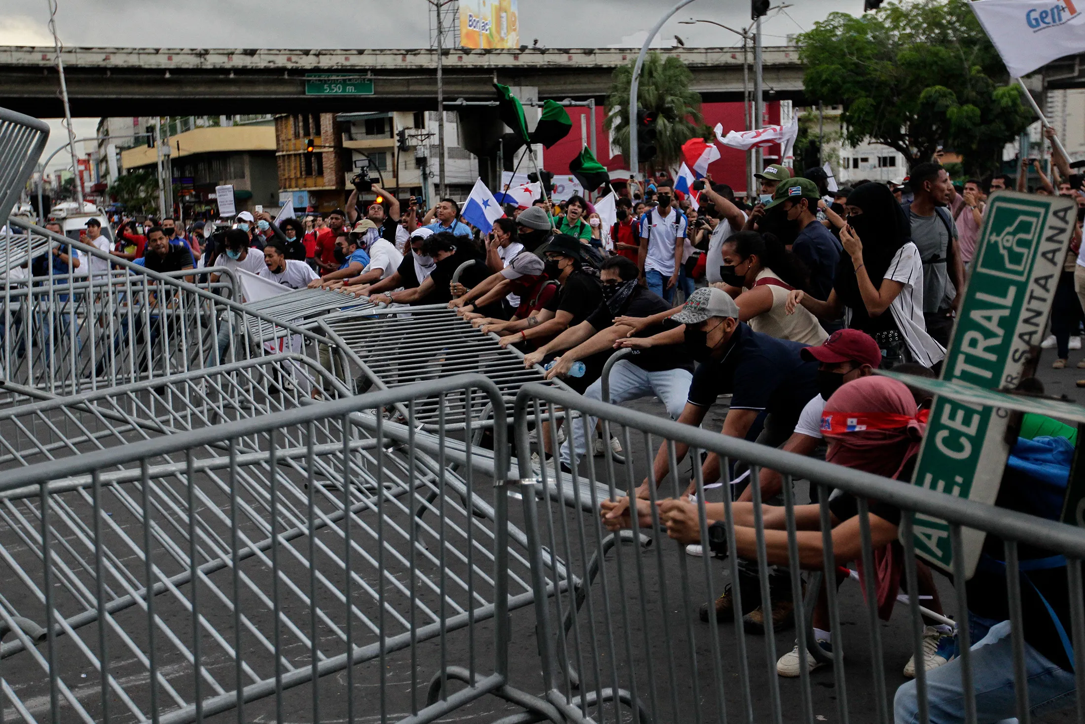 Demonstrators break down a barrier during a protest against inflation in Panama City, on July 12.