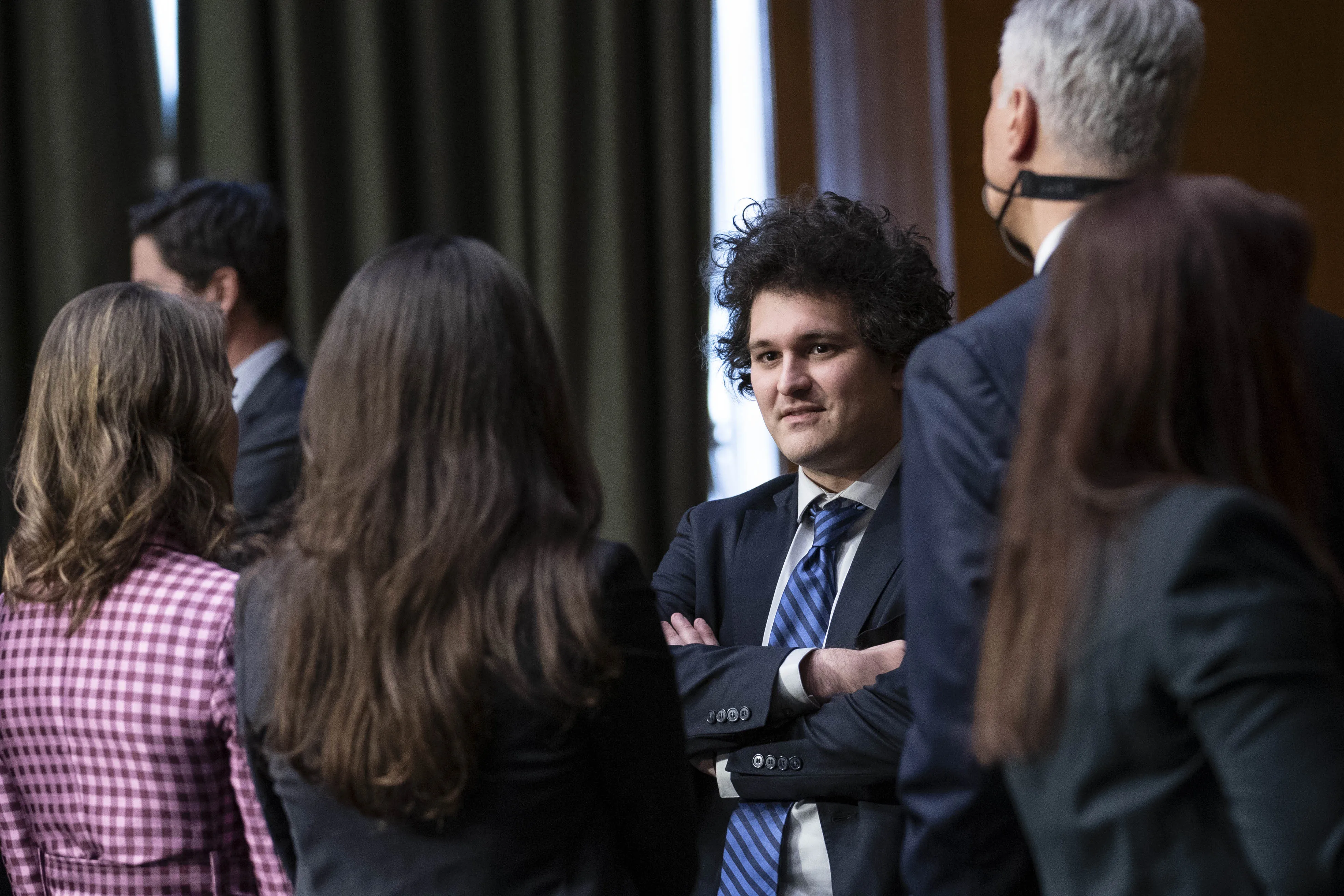 Sam Bankman-Fried, center, following a Senate Agriculture, Nutrition and Forestry Committee hearing in Washington, D.C., on&nbsp;Feb. 9, 2022.&nbsp;