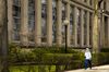 A pedestrian wearing a protective mask walks past on the Massachusetts Institute of Technology (MIT) campus in Cambridge, Massachusetts, U.S., on Monday, April 20, 2020.