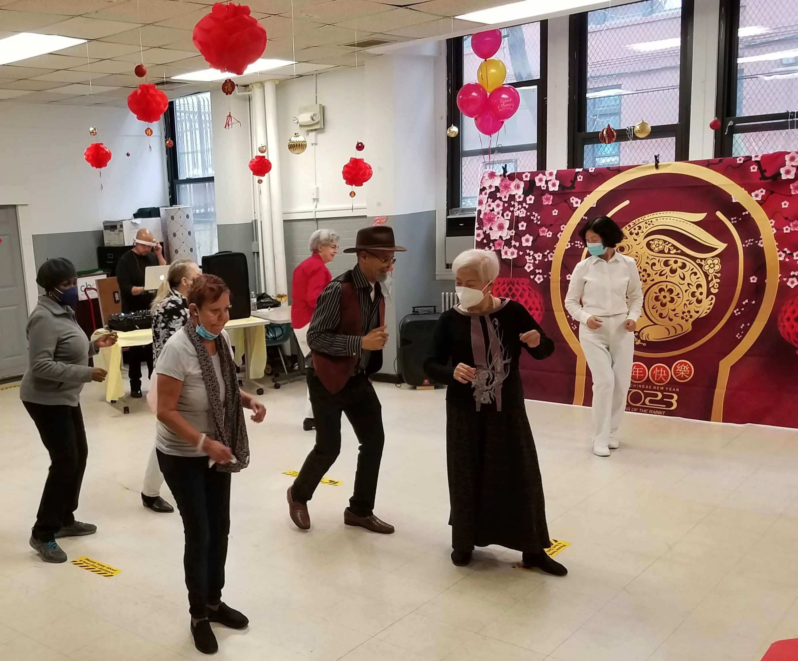 People dance at a Lunar New Year party&nbsp;at Carter Burden Network’s older adult center in East Harlem in January 2023. More lower-income Asian Americans are moving into the traditionally Latino neighborhood, and into its many public housing buildings.