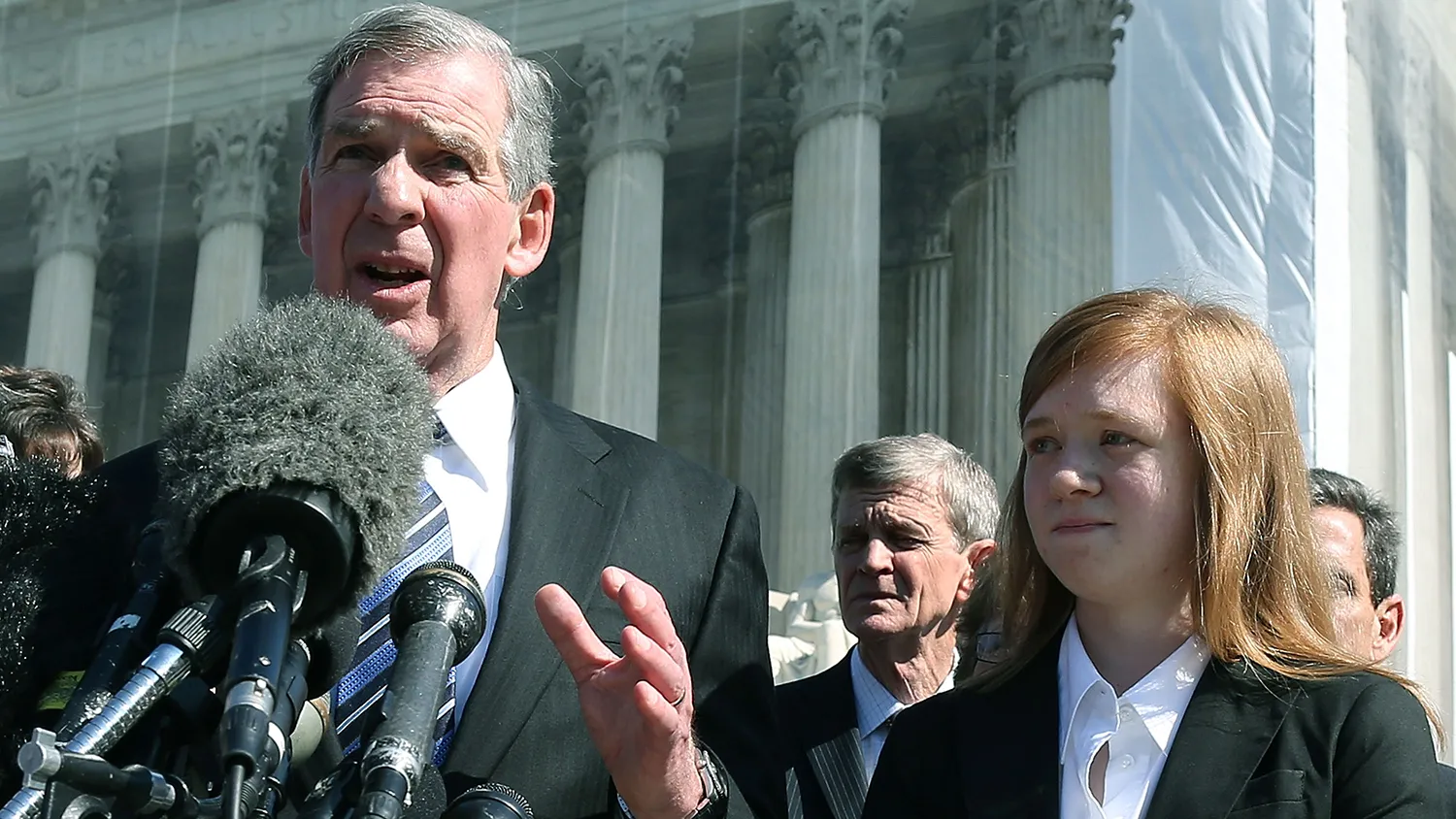 Attorney Bert Rein speaks to the media while standing with plaintiff Abigail Fisher after the Supreme Court heard arguments in her case on Oct. 10, 2012 in Washington.
