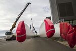 Protective covers sit on wind turbine blades as they are moved at the Vestas Wind Systems A/S blade factory in Lem.