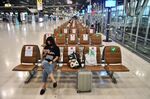Passengers sit in socially-distanced seats in the departures terminal at Suvarnabhumi International Airport in Bangkok on June 3.