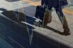 A businessman is reflected on an electronic stock board outside a securities firm in Tokyo, Japan