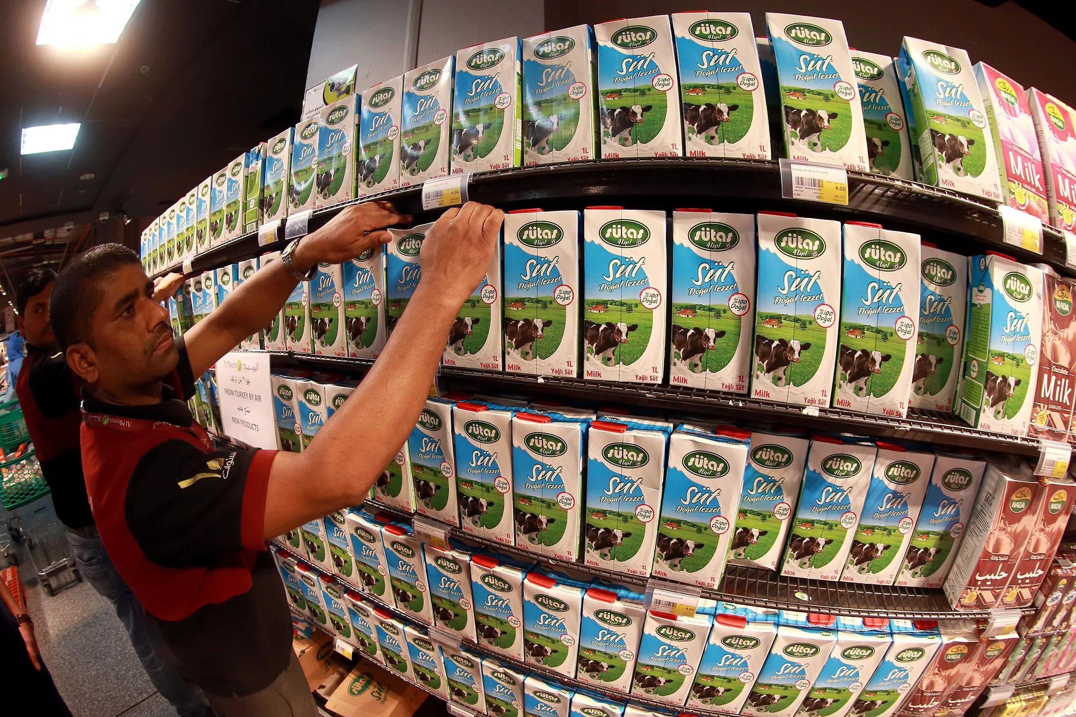 A store attendant tidies the shelves at a market in Doha.