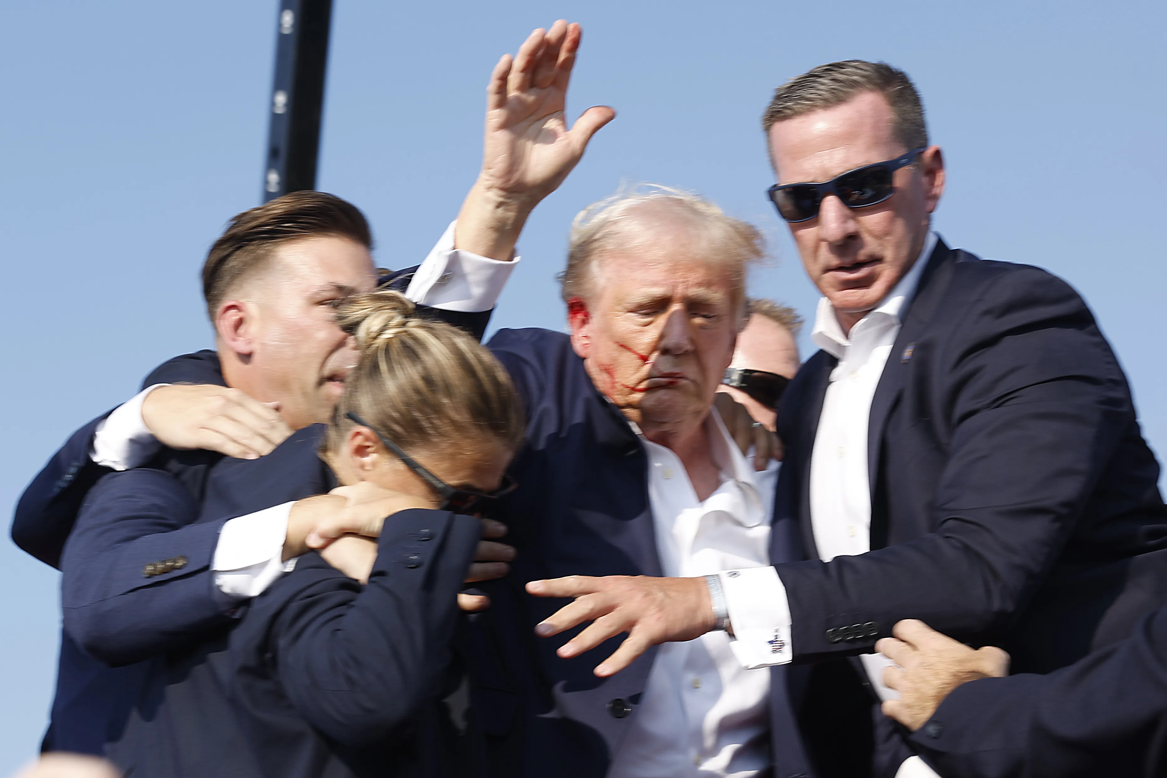 Former US President Donald Trump is rushed offstage after a shooting at a rally on July 13 in Butler, Pennsylvania.