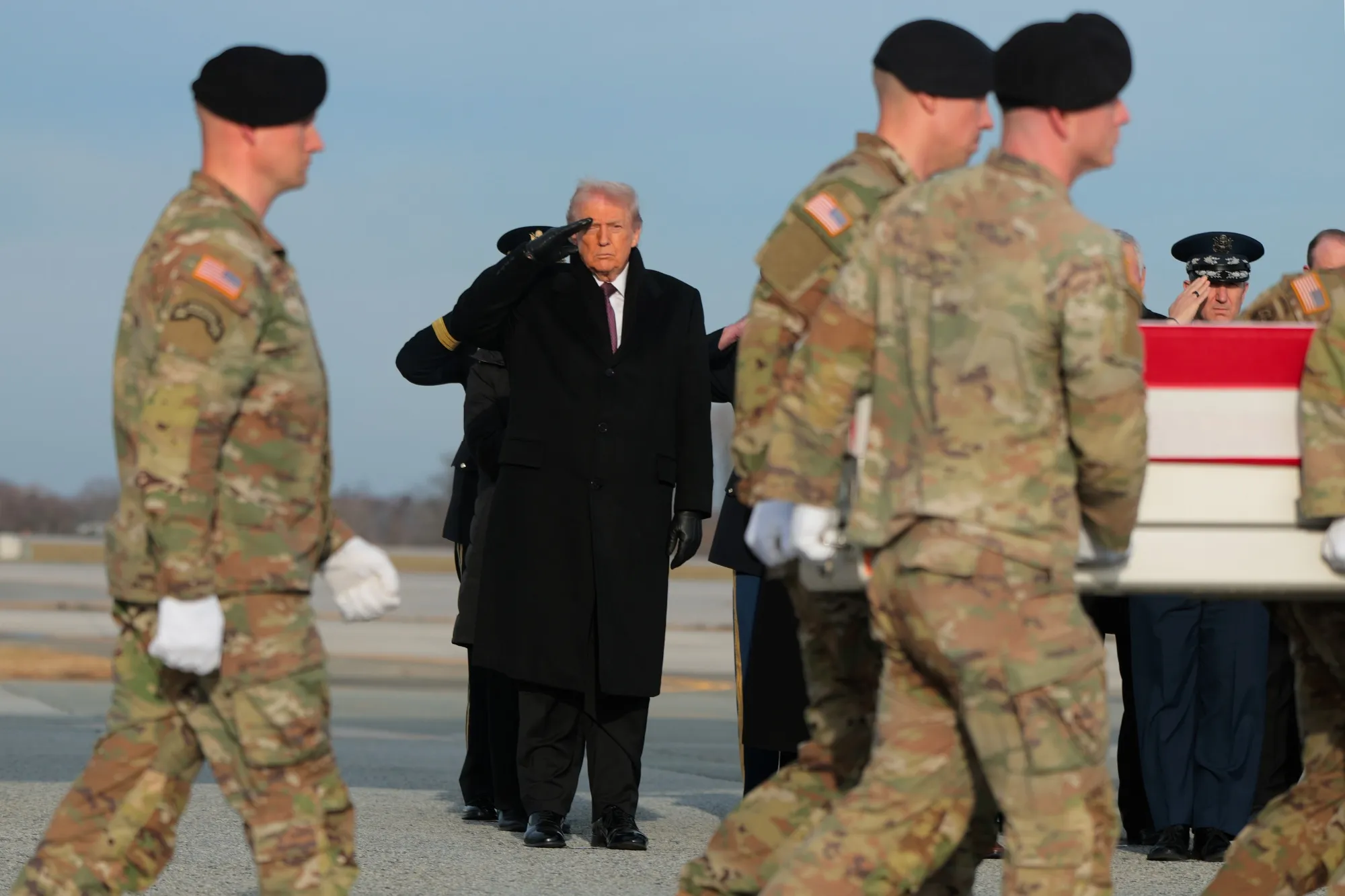 President Donald Trump salutes as a US Army carry team moves a flagged-draped transfer case containing the remains of Iowa National Guardsman Sgt. William Nathaniel Howard at Dover Air Force Base in Dover, Delaware on Dec. 17.&nbsp;