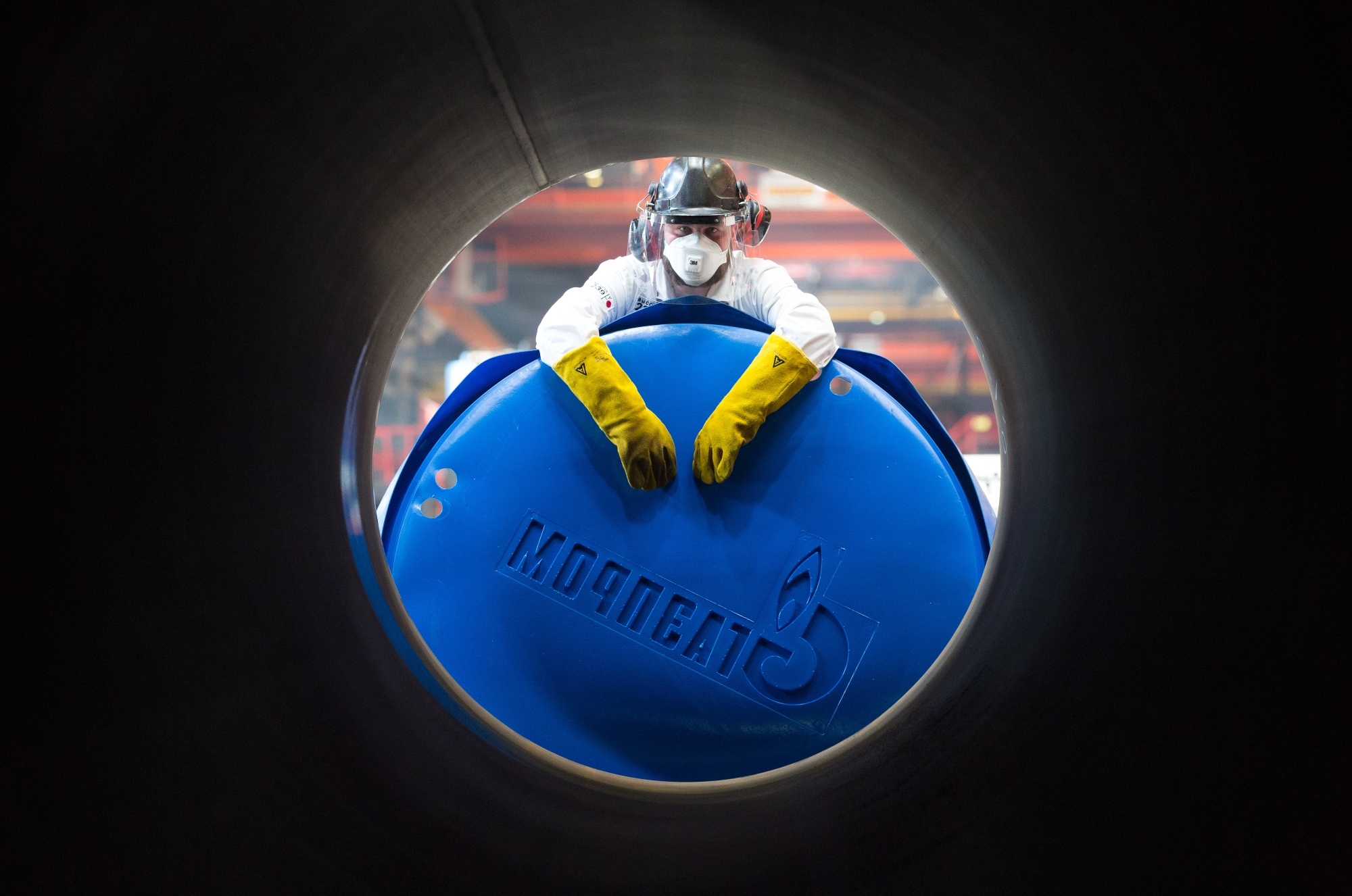 Gazprom PJSC finishing cap worker to steel pipe in Chelyabinsk, Russia.