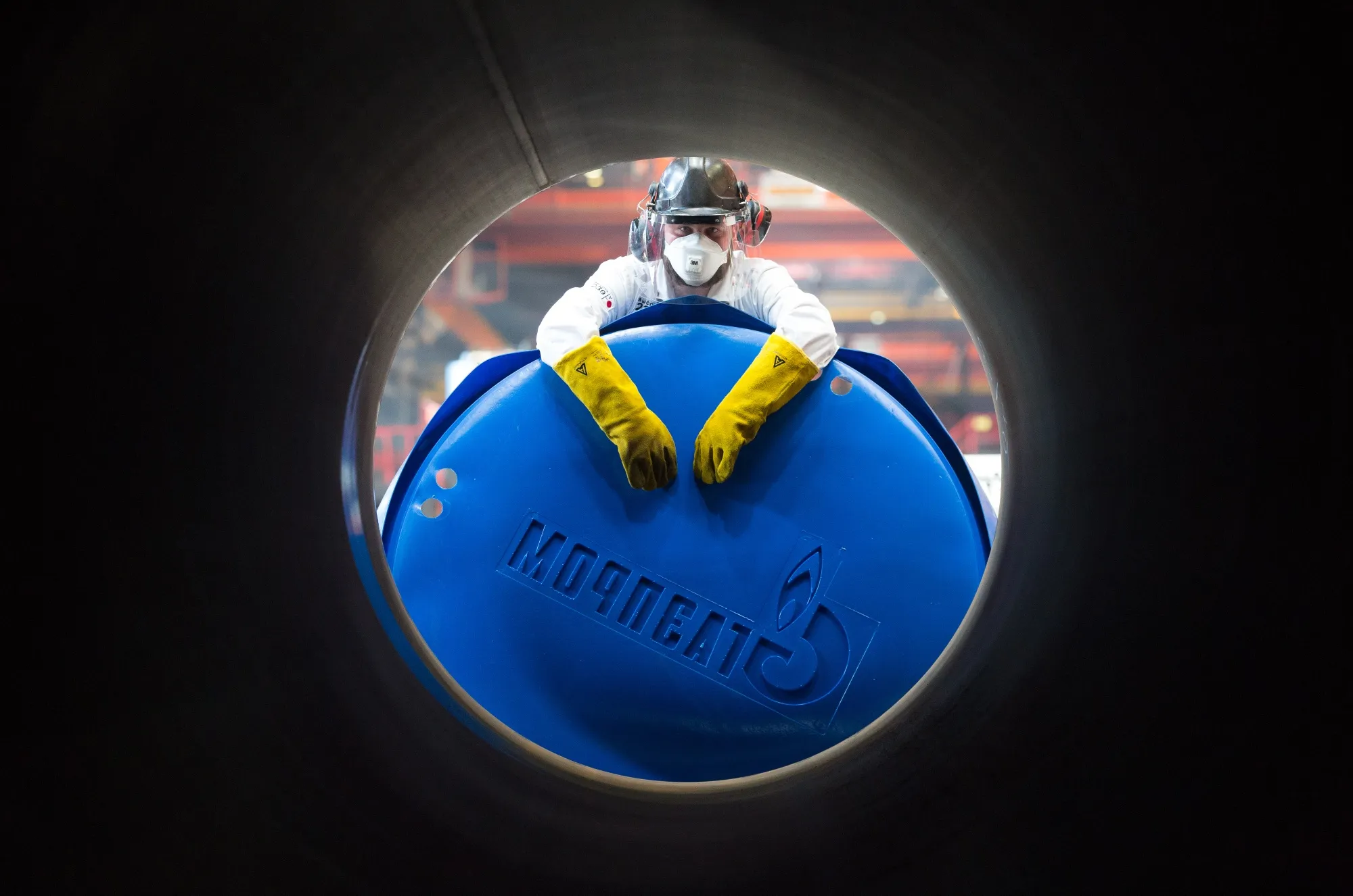 A worker a Gazprom PJSC end cap to a steel pipe in Chelyabinsk, Russia.