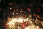 Mourners gather at the site of explosions in the southern suburbs of Beirut in Lebanon.