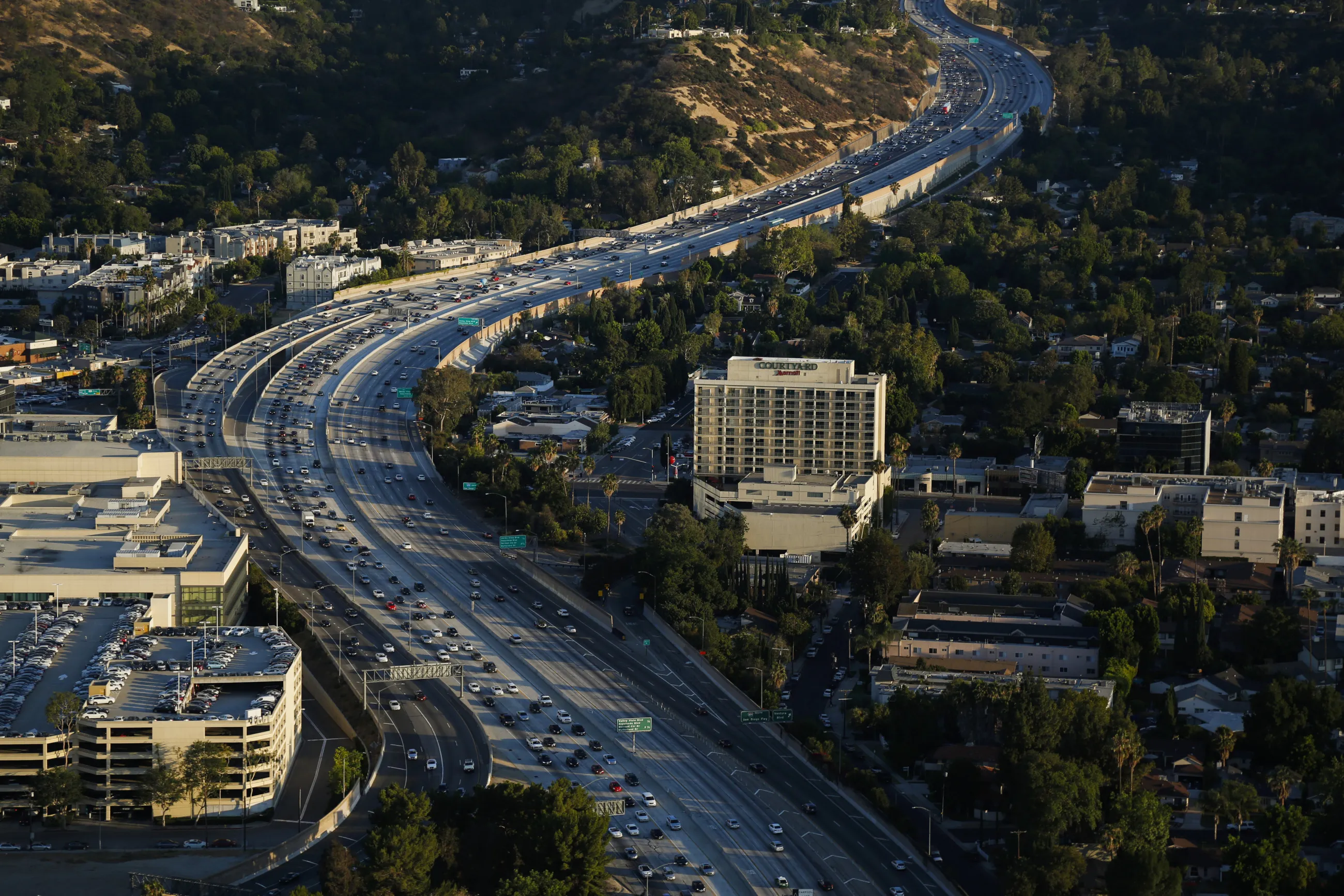 Vehicles sit in rush hour traffic on the Interstate 405 freeway by the Sepulveda pass in this aerial photograph taken over Los Angeles.