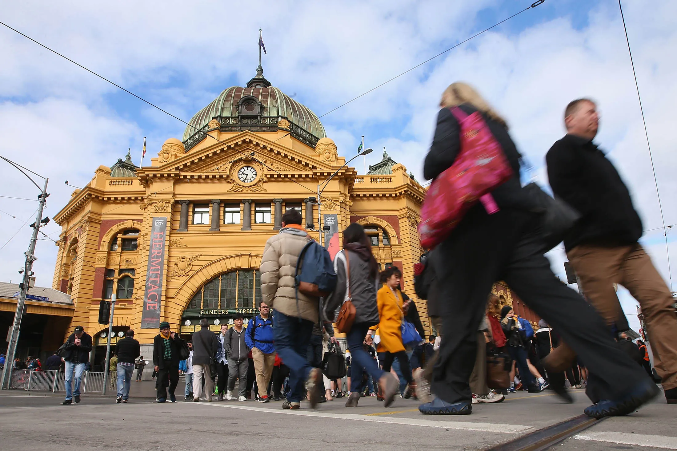 Commuters leave and arrive at Flinders Street Station in Melbourne. The RBA is trying to orchestrate a transition away from mining investment to other industries in the economy, using low rates and a weaker dollar as a tailwind for industries.
