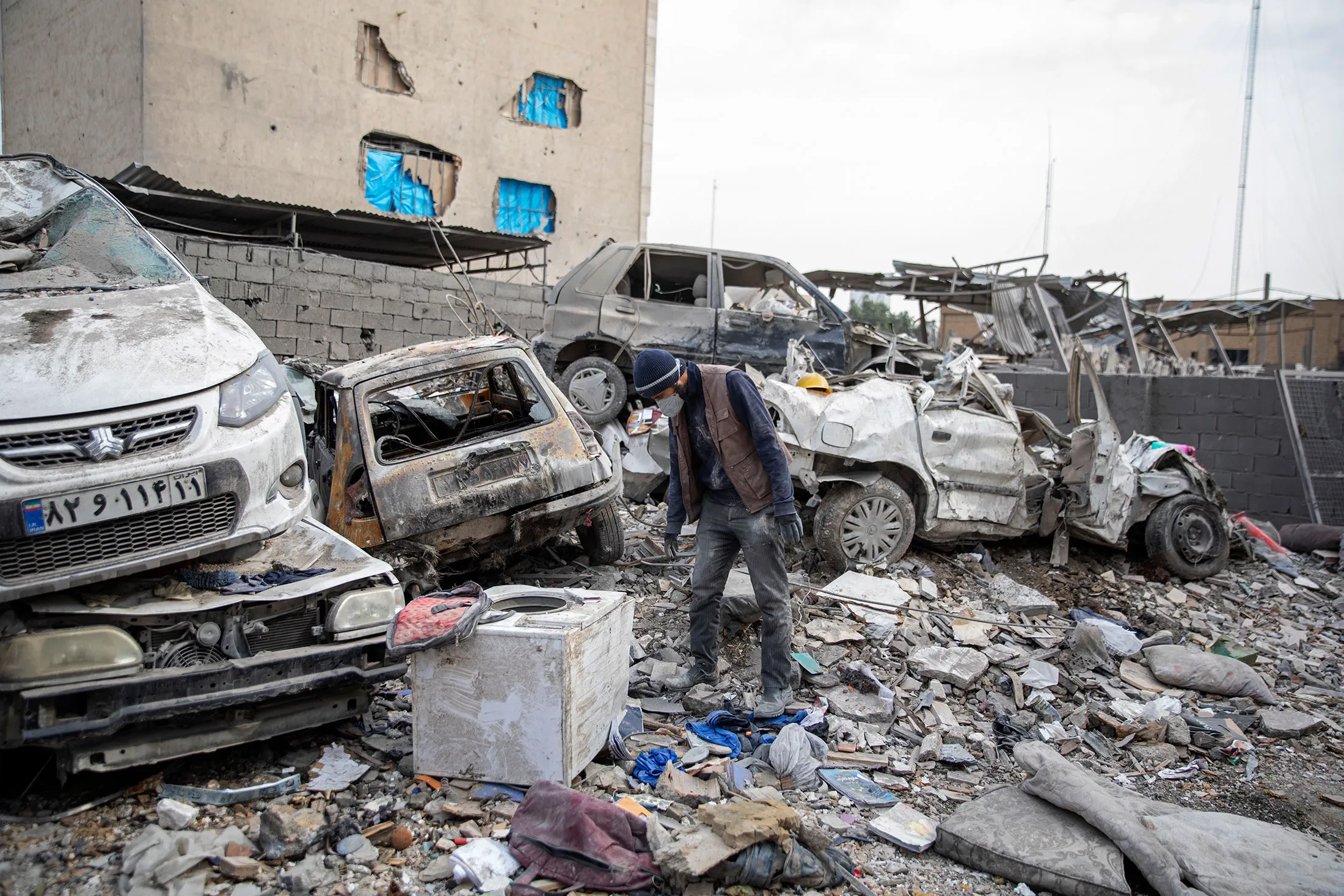 Buildings and vehicles destroyed following airstrikes in Tehran, on March 12.