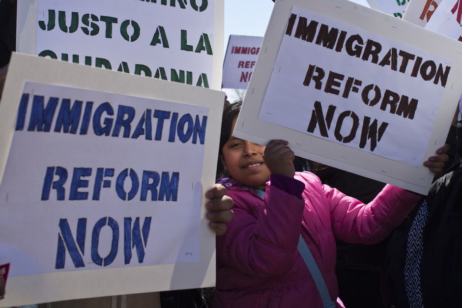 A girl holds up a sign at an immigration reform rally in Jersey City, New Jersey, in 2013.