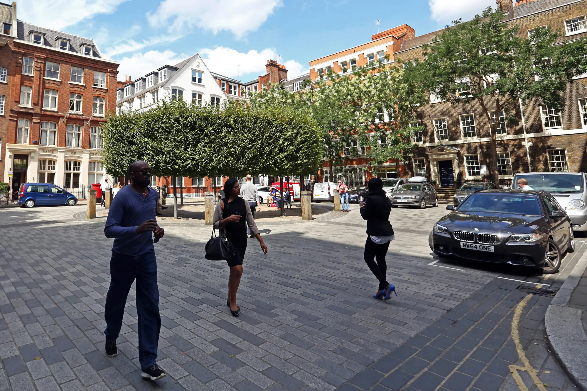 Pedestrians pass through the Devonshire Square in London.
