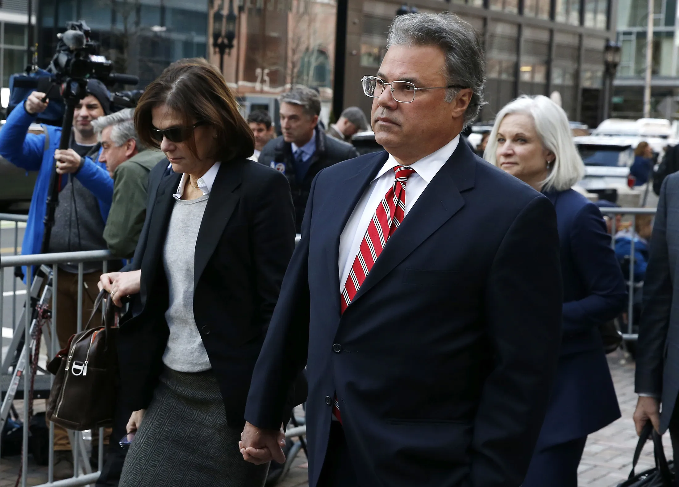 Elizabeth Henriquez and her husband, Manuel, leave federal court in Boston on April 3, 2019.