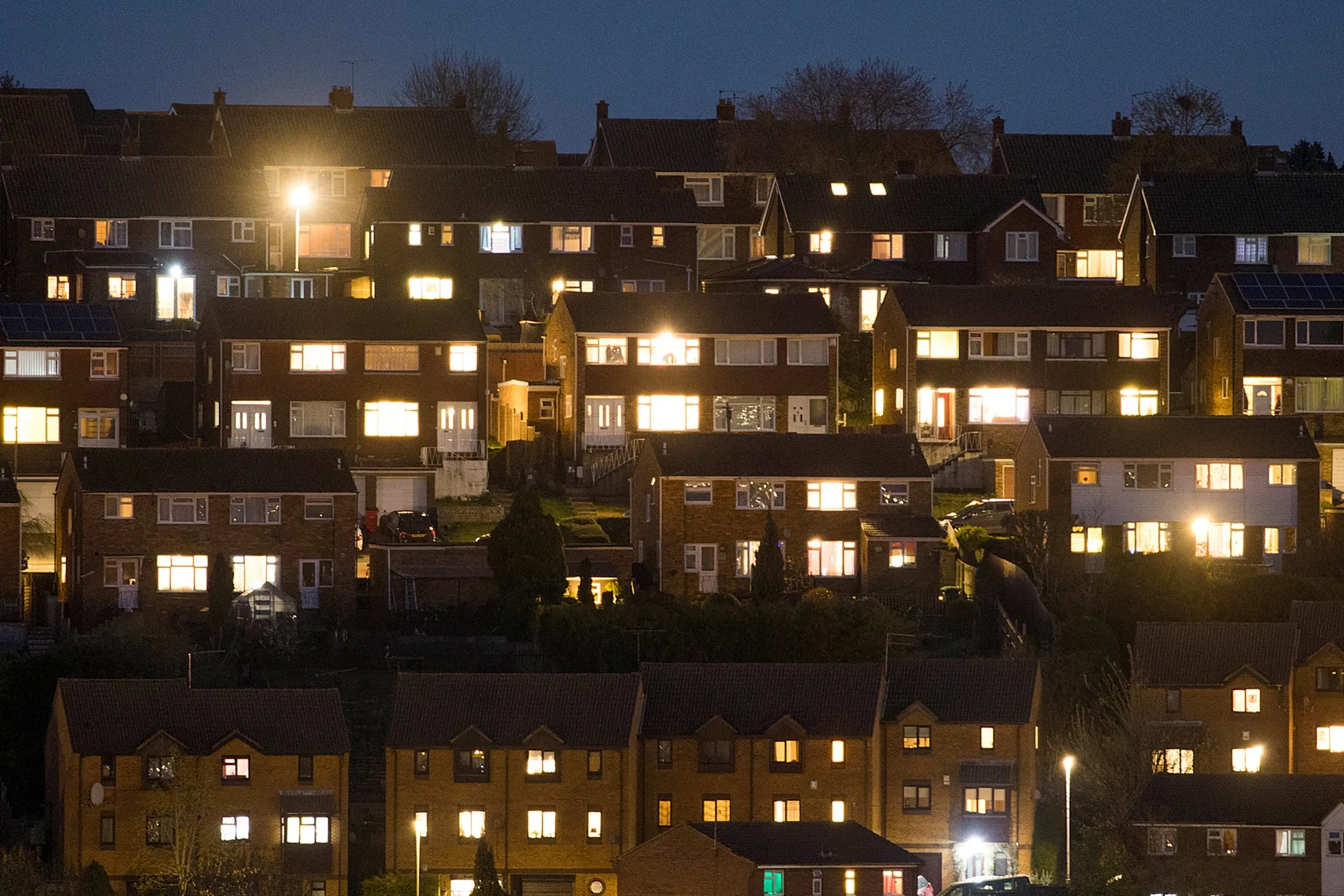 Lights illuminate the windows in residential properties in High Wycombe, U.K.