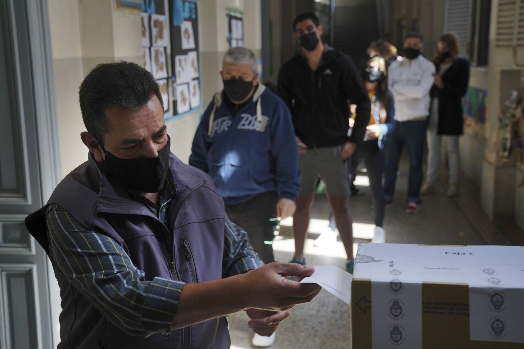 A voter casts a ballot at a polling station during the primary elections in Buenos Aires, Argentina, on Sunday, Sept. 12, 2021. 