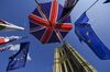 An umbrella featuring the design of the Union flag, also known as the Union Jack, stands near European Union (EU) flags outside the Houses of Parliment in London, U.K., on Tuesday, Oct. 22, 2019. U.K. Prime Minister Boris Johnson will find out Tuesday evening whether he has any chance of getting his Brexit deal through Parliament -- and whether he can do it ahead of his Oct. 31 deadline.