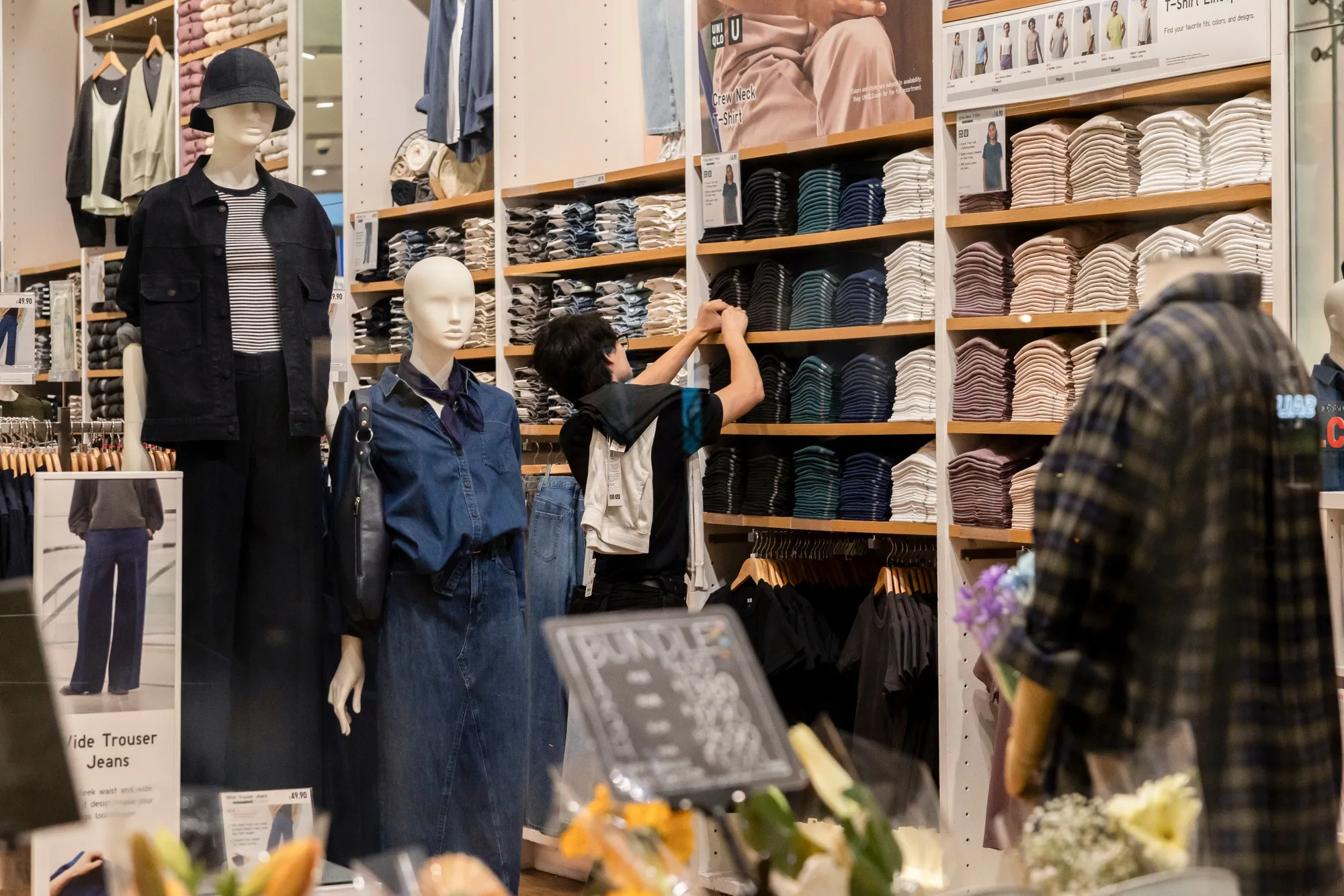 A retail worker organizes merchandise in New York City.&nbsp;
