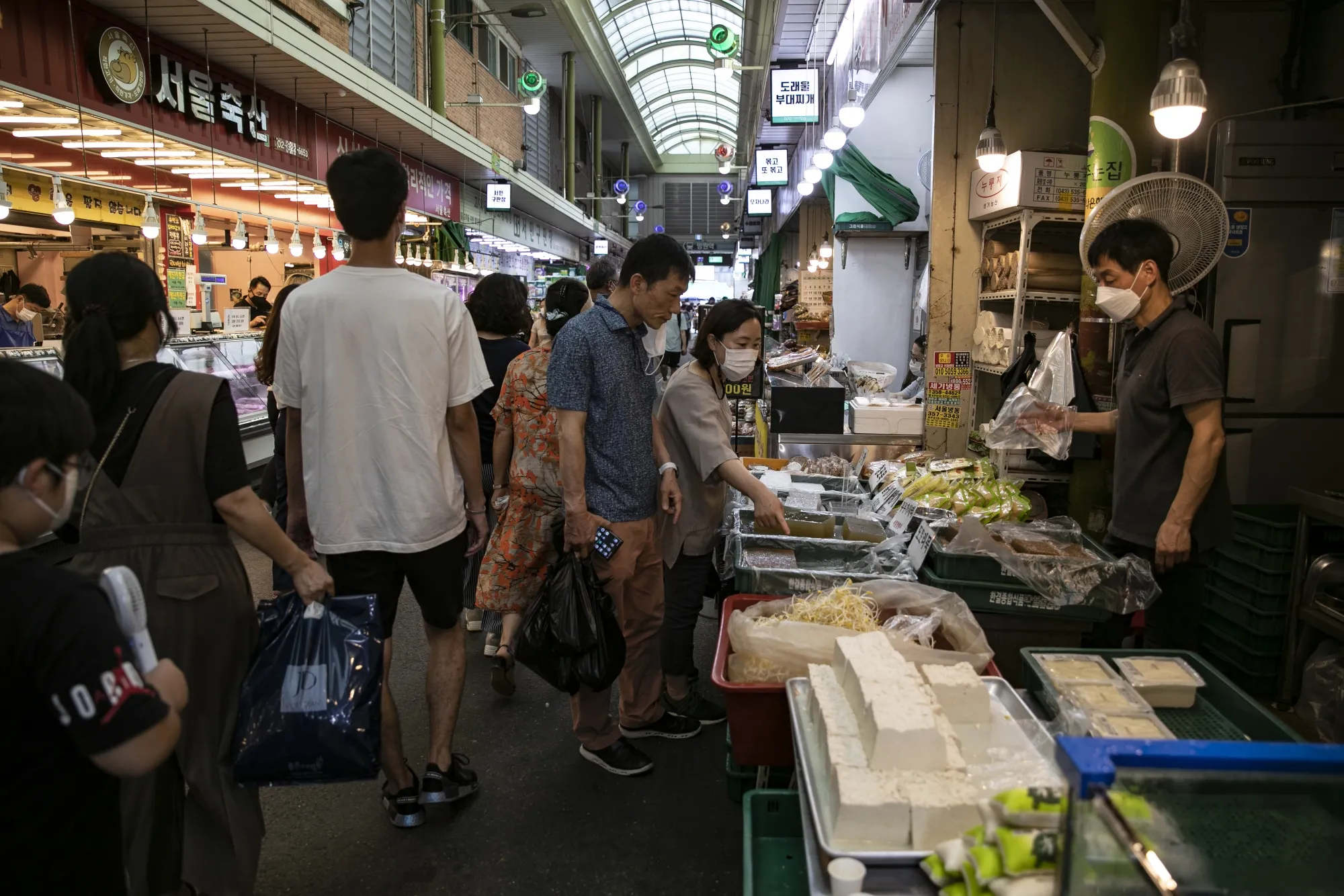 Shoppers browse for food items at a market in Seoul.