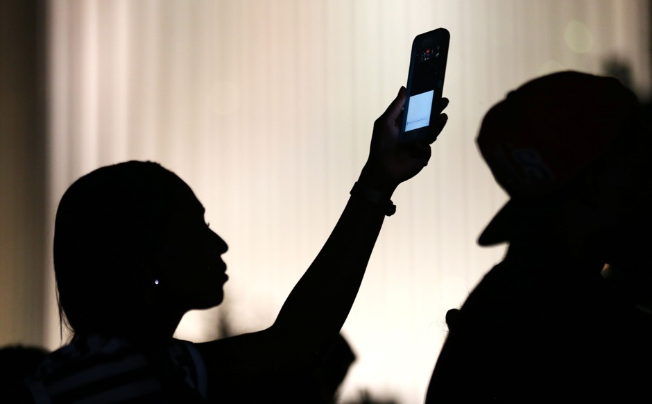 A protester uses her phone during a night of demonstrations over the police shooting of Keith Scott in Charlotte, North Carolina.