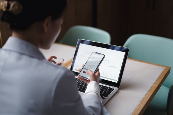 Back view of a young woman checking a stock market chart