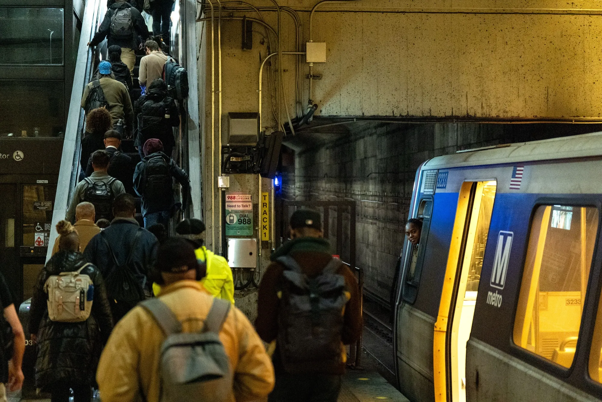 Commuters near a red line train at Union Station in Washington, D.C.