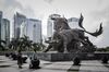 People stand in front of a sculpture of bulls at the entrance to the Shenzhen Stock Exchange building in Shenzhen, China, on Tuesday, Aug. 23, 2016. Derivative markets are pointing to renewed bets on yuan depreciation, with a three-month measure of expected price swings poised for the biggest monthly increase since January.