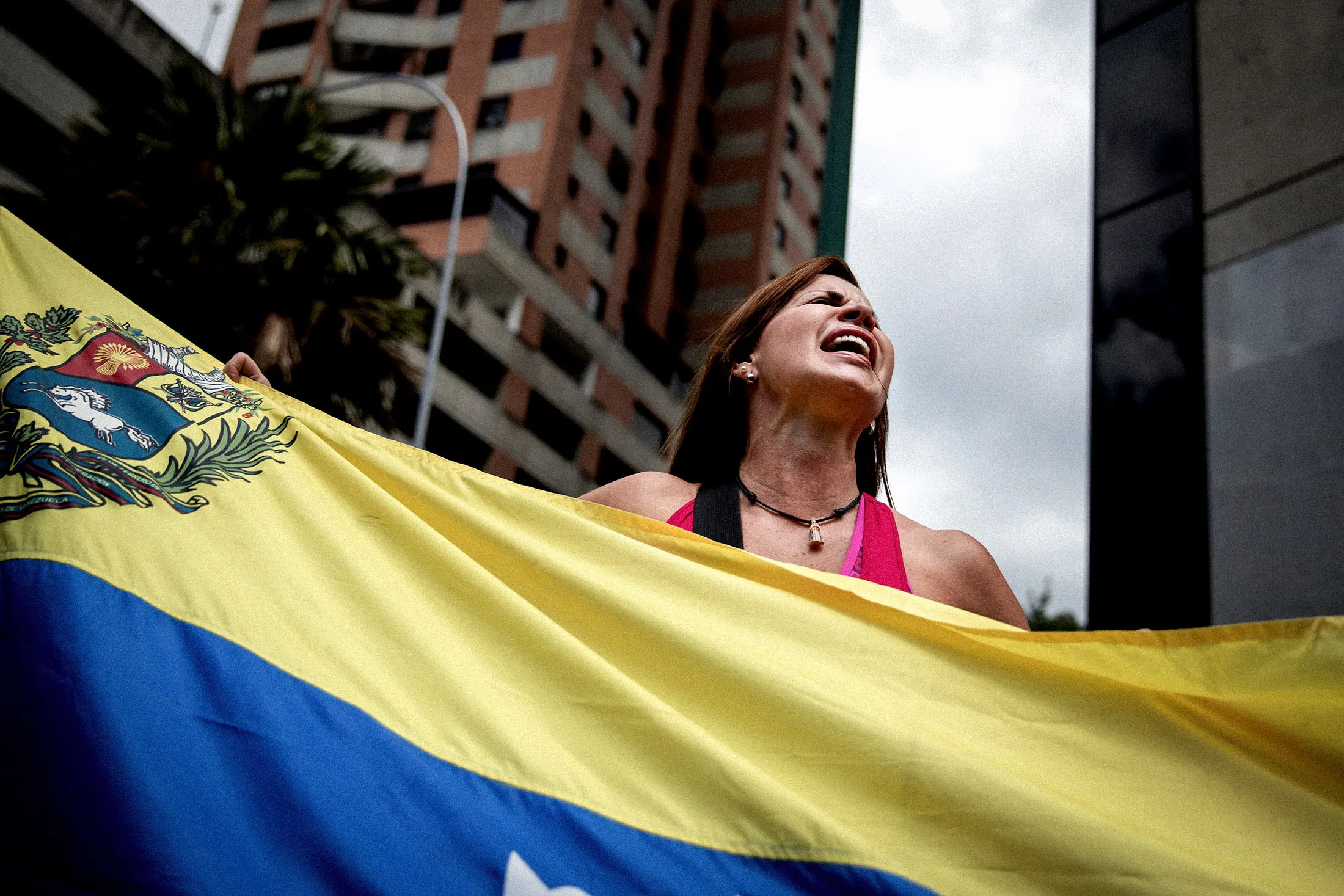A demonstrator holds a Venezuelan flag during a protest against President&nbsp;Nicolas Maduro in Caracas.