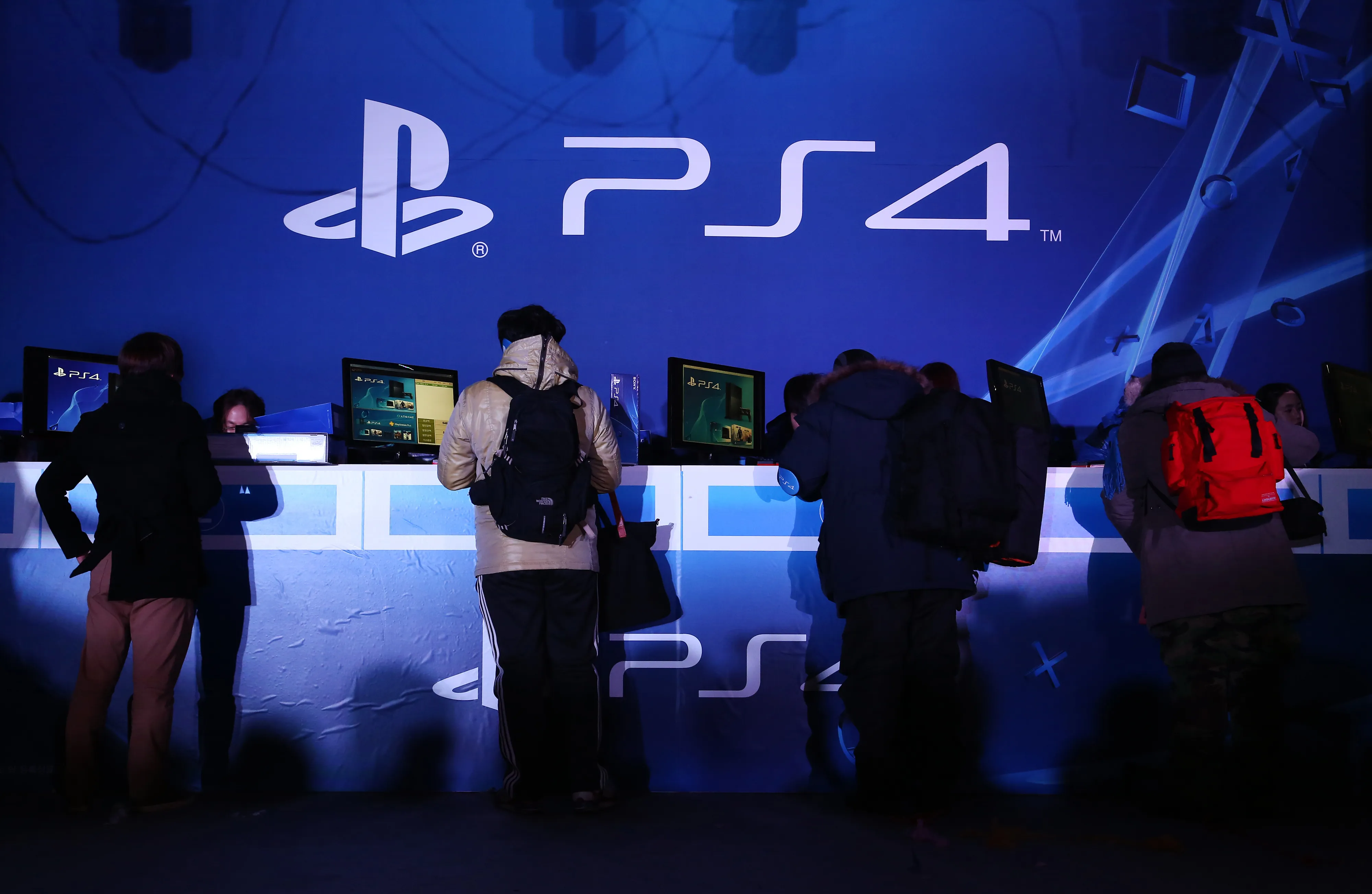 Customers purchase Sony Corp.'s PlayStation 4 (PS4) game console during the console's launch event in Seoul. Photographer: SeongJoon Cho/Bloomberg
