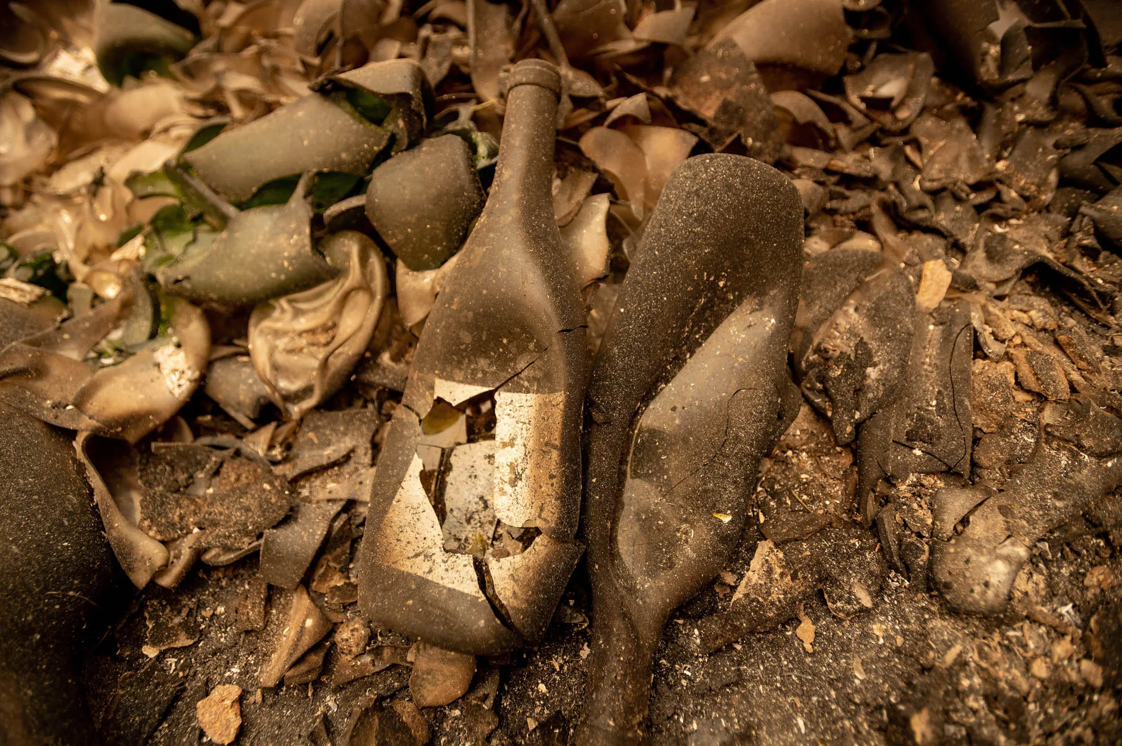 A pile of melted and burned wine bottles lies at Castello Di Amorosa winery as the Glass fire continues to burn in Calistoga, Calif.,&nbsp;on October 1.
