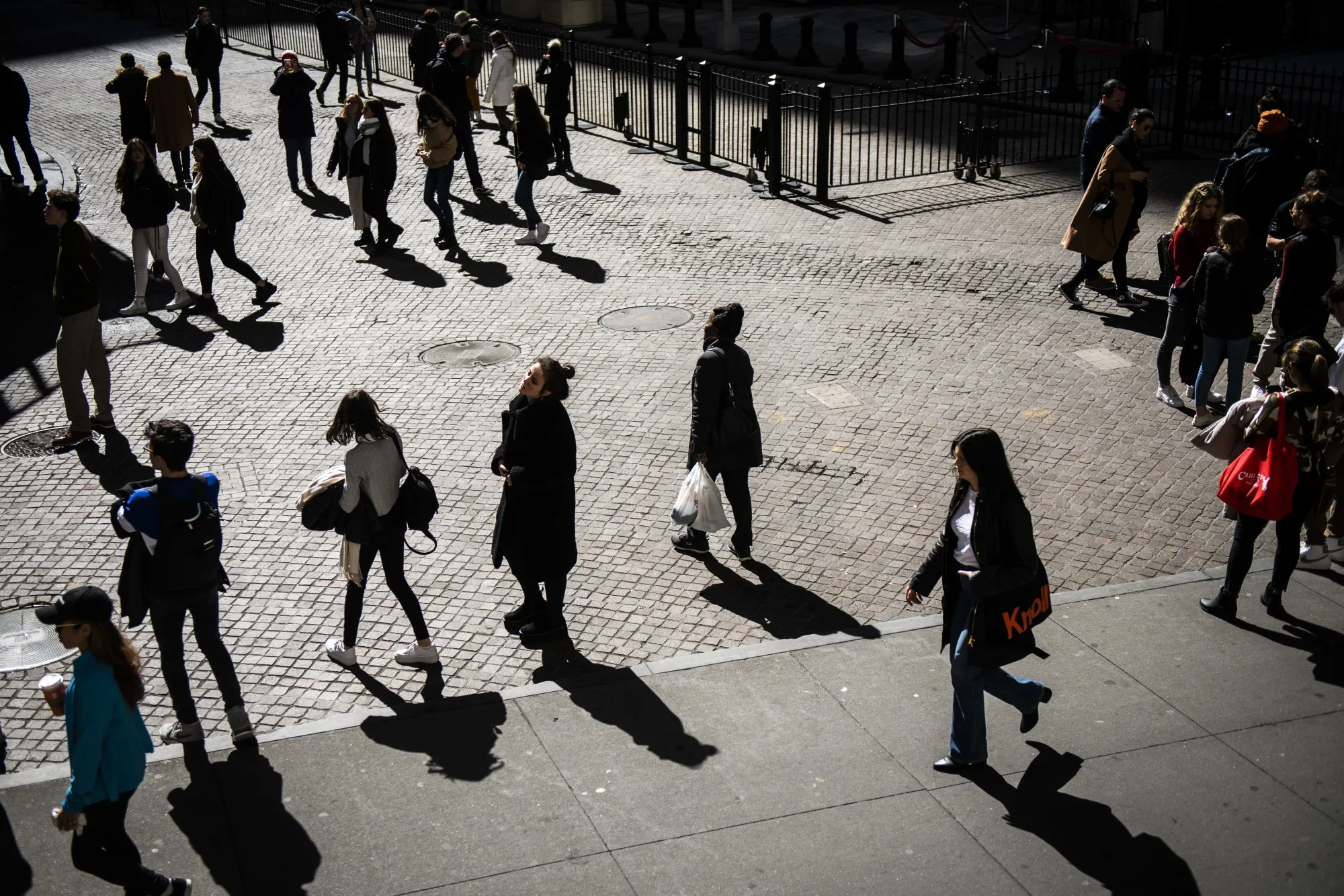Pedestrians walk along on Wall Street near the New York Stock Exchange on March 13.&nbsp;