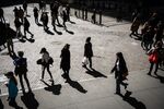 Pedestrians walk along on Wall Street near the New York Stock Exchange on March 13. 