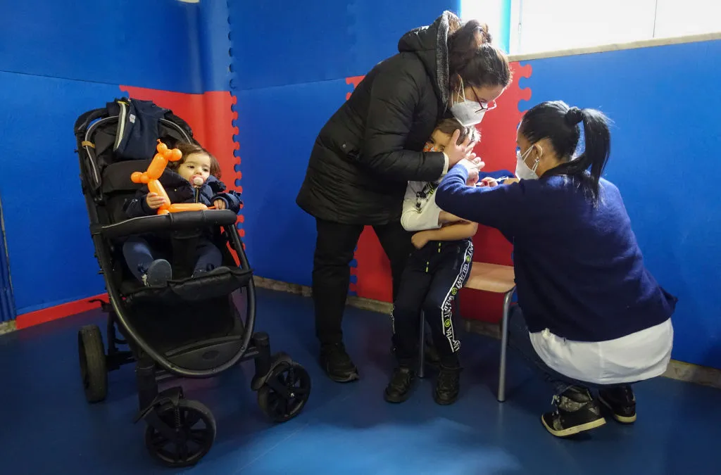 A nurse gives a child a vaccination in Naples.&nbsp;